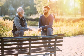 Happy father and son enjoying outdoors in park.