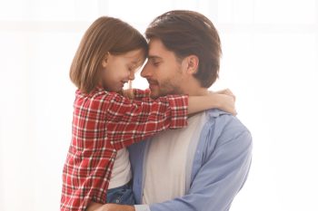 Fatherhood, care, family concept. Lovely father and daughter embracing at home, panorama with copy space